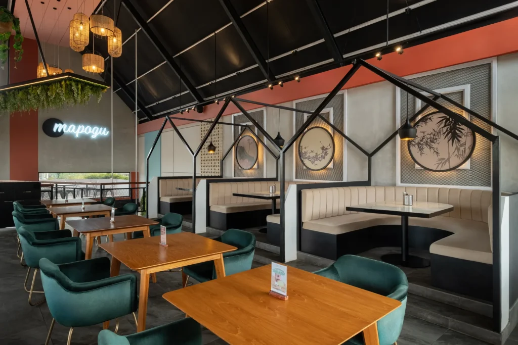 Modern cafe interior with booth seating and wooden tables