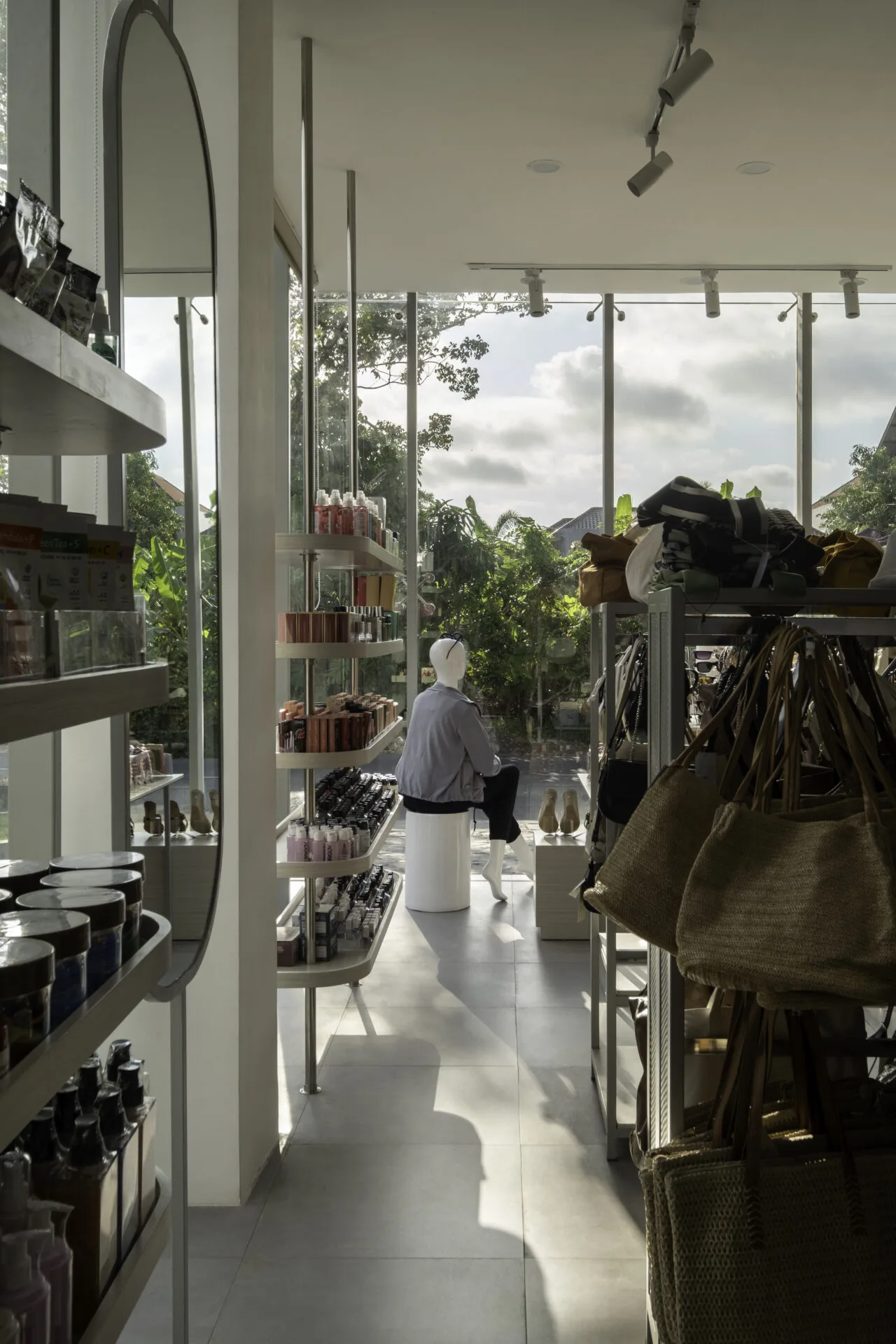 Light-filled boutique interior with mannequin by window