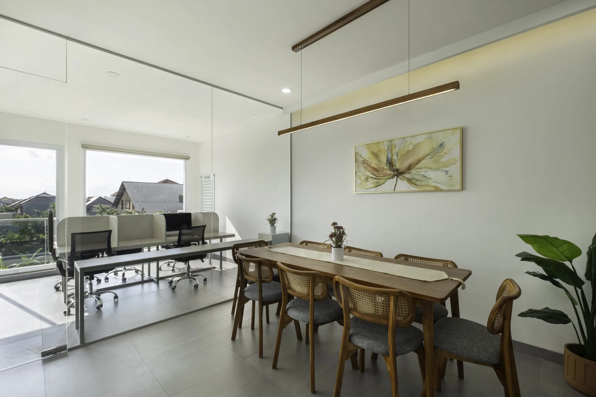 Modern meeting room with wooden table and glass office