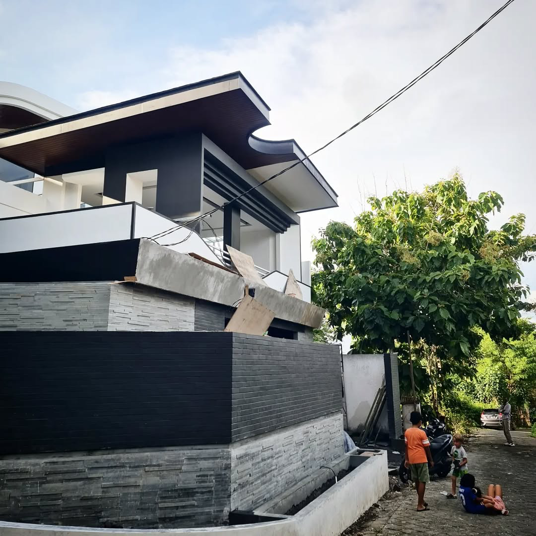 Modern house with stone wall and tall tree