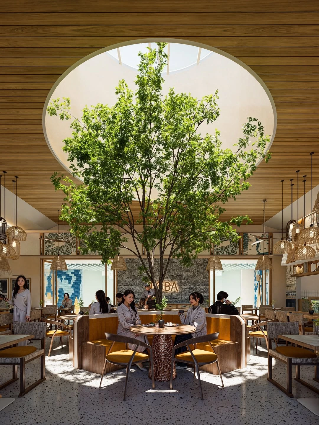 Indoor cafe with central tree under circular skylight