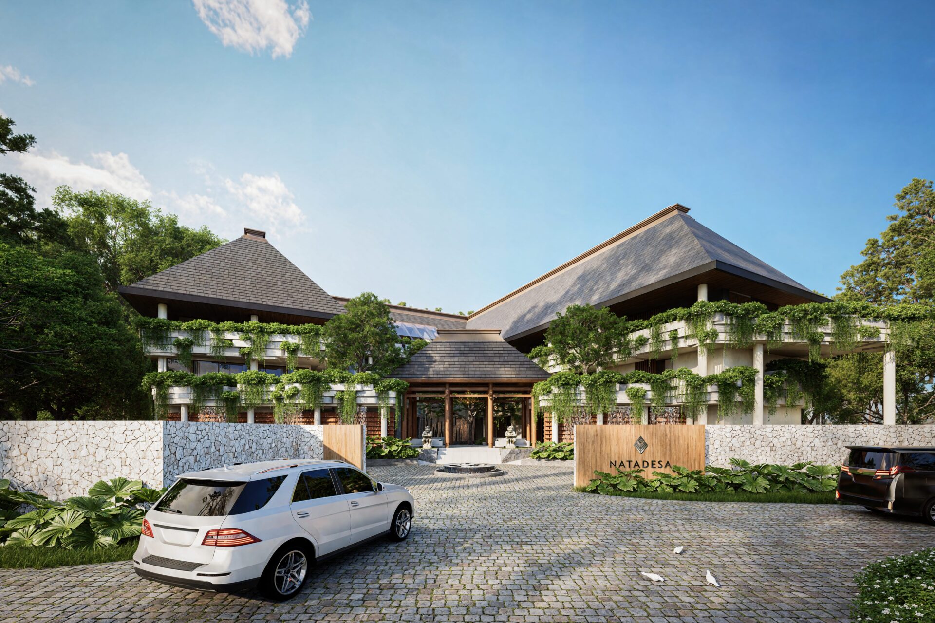 Resort entrance with sloped-roof buildings and cars